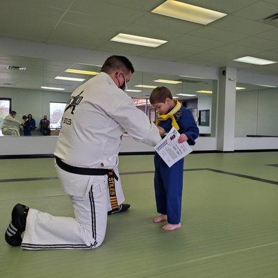 Mr. P awarding a new belt to our awesome student that passed testing!