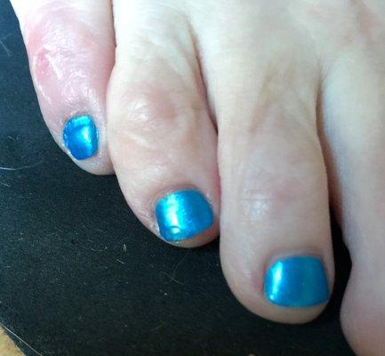 Bad cuticle lines and chip repaired by manicurist before I left