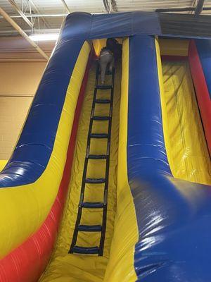 One of the jumping houses! This one has a tall ladder the kids climb up and a few long slides to go down! Super fun!