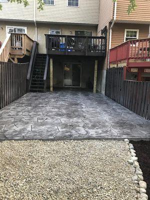 Textured Concrete offers a wonderful entertainment space for townhouse back yard. Attractive color with flagstone pattern.