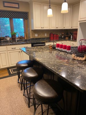 Kitchen sink area cabinets and island.