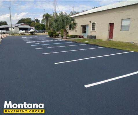 Asphalt sealcoating and re-striping.