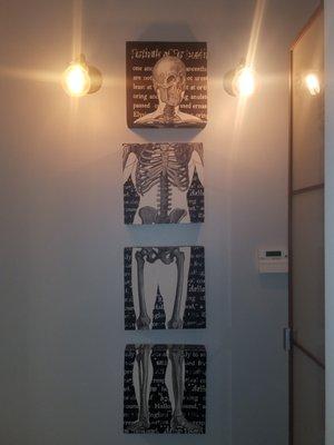 Cool skeleton on multiple canvases near massage room.