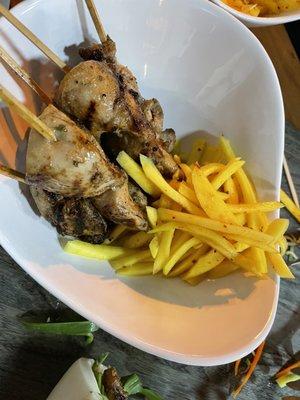 Chicken skewers with pickled mango on the side