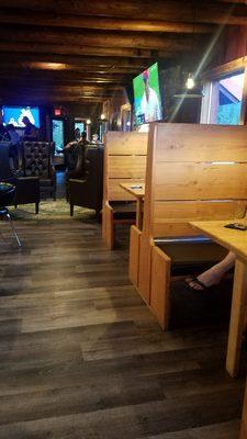 Booths, club chairs, bar and large TVs.