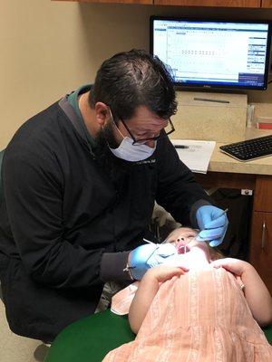 Dr. Bradley examining my daughters teeth (very first dentist appointment)