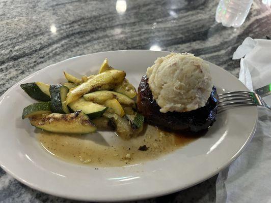 Round meatloaf wrapped with bacon. Zucchini, squash, and mashed potatoes.