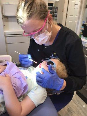 Our daughter getting "lipstick" during her appointment. They do whatever necessary so kids feel comfortable!