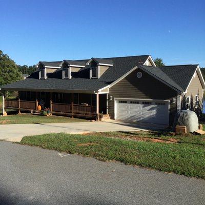 Custom built home using Legacy Pre-Finishing custom solid color LP SmartSide Lap Siding and custom stained Panels and trim.