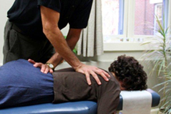 Thoracic spinal adjustment lying prone on a  adjustment