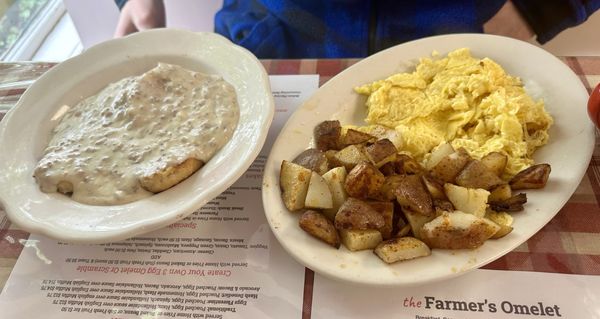 Biscuits and gravy, 2 scrambled eggs, breakfast potatoes, and baked beans