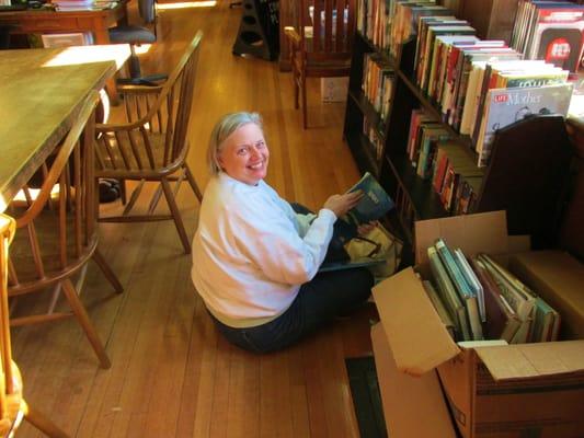 Scruffy person looking at used books