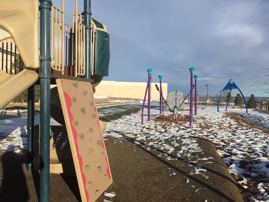 Multiple play structures at the Ridge rec outdoor park including zip slides and zip line.