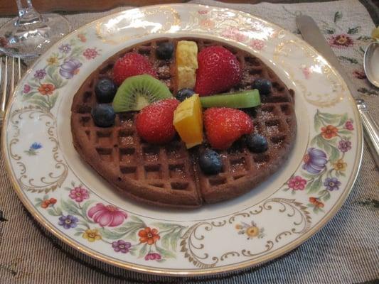 Homemade chocolate waffle with fresh fruit.