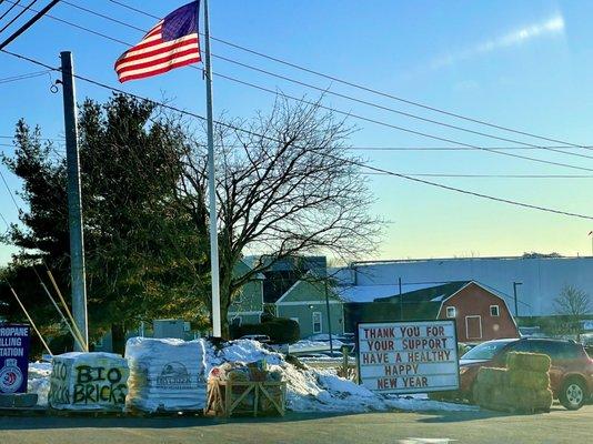 Thank you sign next to America flag