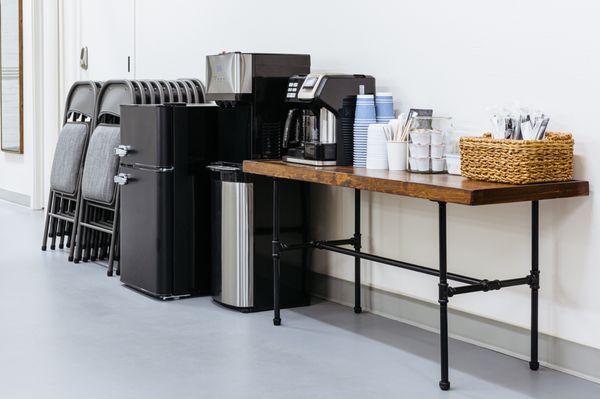 Beverage station with filtered drinking water, coffee station, and mini fridge.