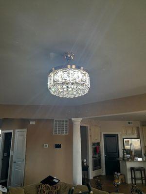 Chandelier with retractable fan blades