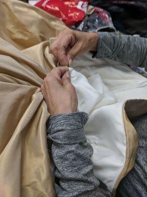 One of our seamstress doing an emergency zipper repair on a wedding gown.