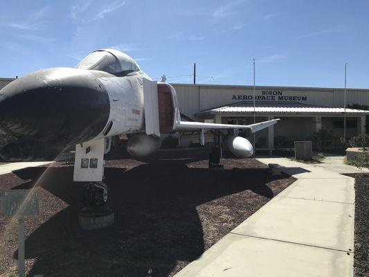 Fighter jet out front.