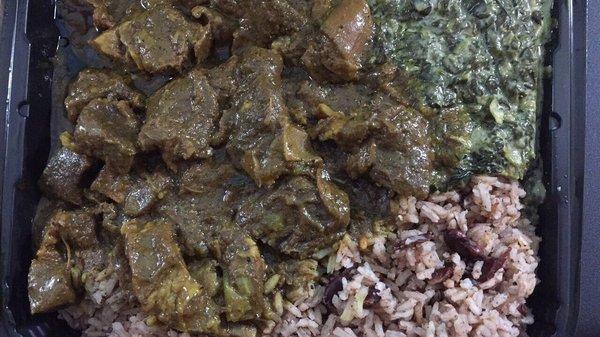 Curry goat, creamed spinach, rice and peas (beans)