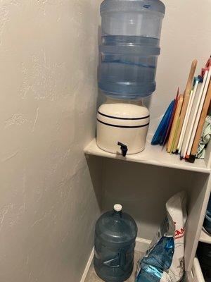 Five gallon bottle is kept in dispenser in my pantry for easy access.