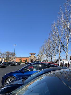 Tesla charging near Lazy dog restaurant