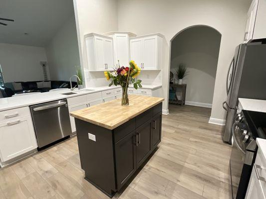 Refaced perimeter in white shaker and the island in dark gray. A butcher block is a great option to add some diversity in textures and color