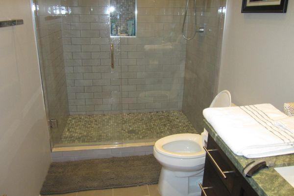 Tile shower with glass doors completed November 2023