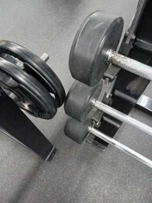 Plates touching barbells. Unsafe. Common at this gym. Management refuses to fix these unsafe issues.