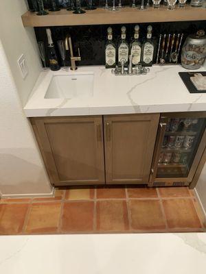 Bar sink, faucet, hidden Scotsman ice maker, beverage cooler.