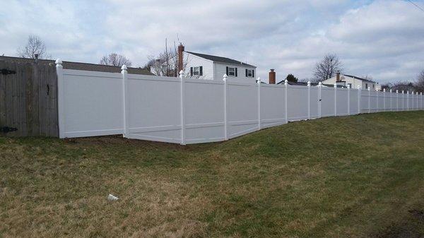 Vinyl fence with custom contour matching.