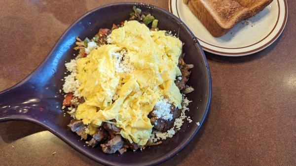 Greek skillet of scrambled eggs with onions, peppers, feta crumbles, and of course, gyro meat. It was accompanied by hash browns and toast.