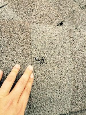 Hail damage to a shingle.