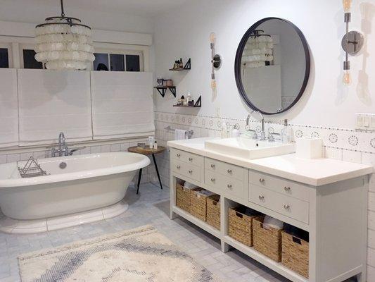 This master bath had a major transformation from dark and masculine to pretty and feminine.