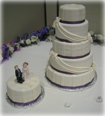 Elegant draping and a custom topper on the grooms cake.