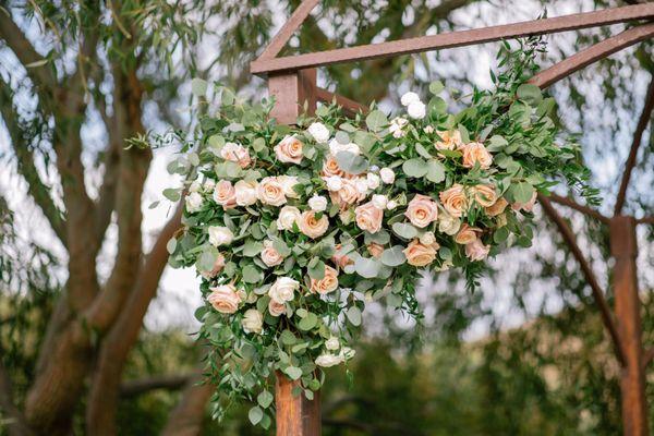 Floral arrangement on pergola during the ceremony