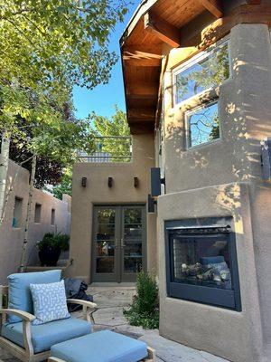 Private patio with comfortable furnishings and indoor/outdoor gas fireplace.