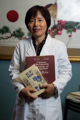 Dr. Xiaohong Tan is pictured here with books she co-authored.