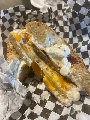 Sesame bagel with egg, sausage, cheese and cream cheese