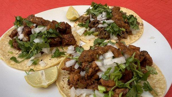 Beef, chicken and el pastor tacos plate