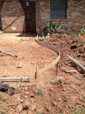 Homeowners requested a curved concrete detail to match existing flower gardens.