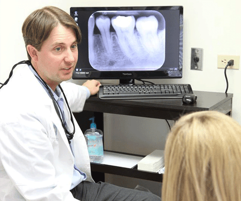 Dr. Bingham explaining an x-ray to a patient