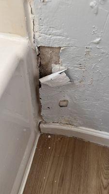 Restroom drywall that's not an emergency to fix, according to the property manager.