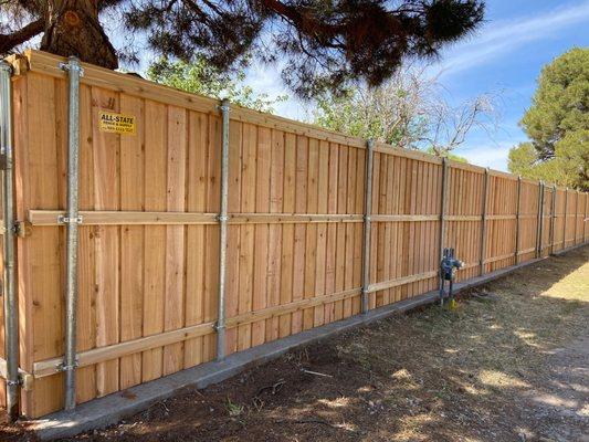 7' Tall Western Red Cedar Board on Board with a Concrete Curb