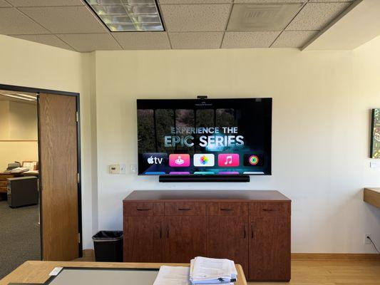 Conference room with a mounted 75" Hisense and the Sonos Arc sound bar.