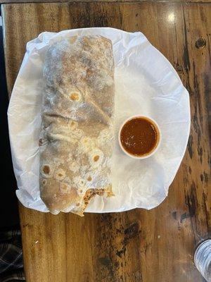 Carne asada burrito with a bite out of it.