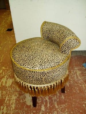 Vanity stool in cheetah print with tassel trim