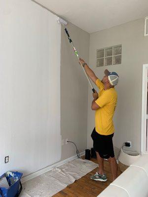 Jacob painting the walls white