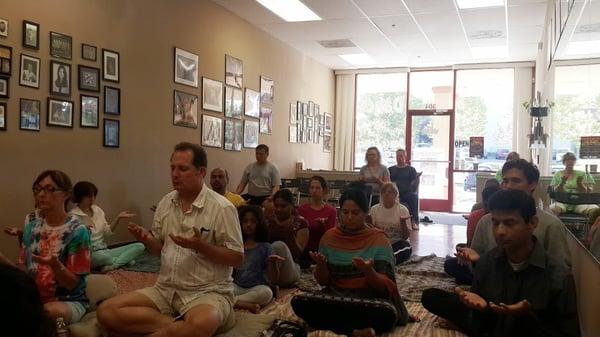 Yogis enjoying Thoughtless Awareness through group meditation.