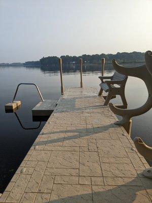 Wave Armor Floating Dock with a bench, kayak rack, and a swim platform with a kayak launch assist.